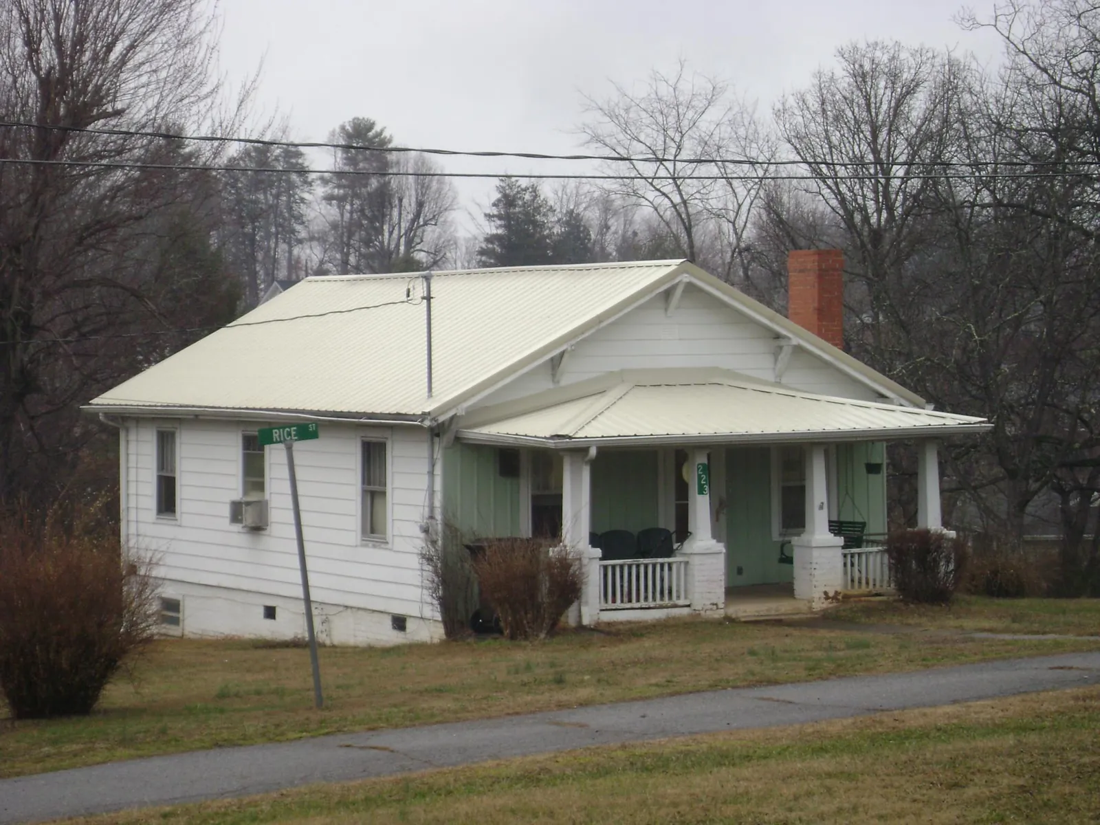 White metal roof on a craftsman bungalow at a street corner in Horse Cave