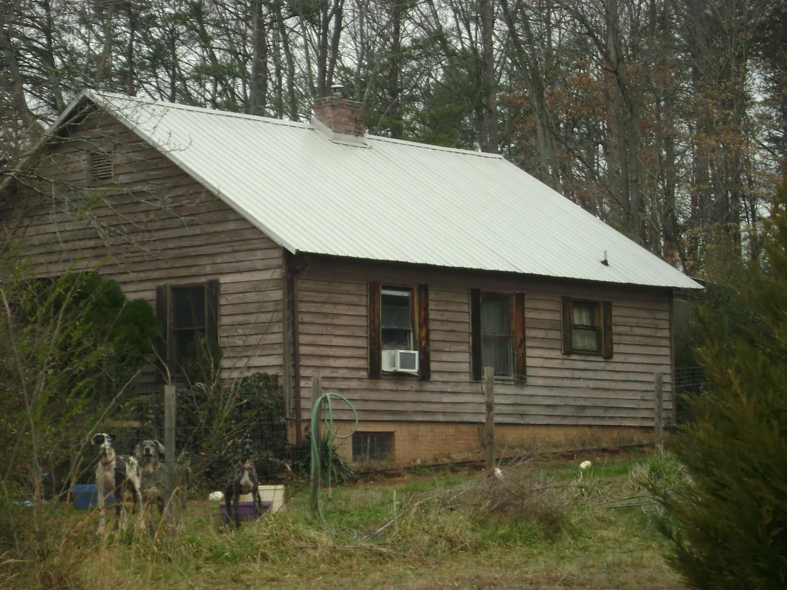 White metal roof on an old wood sided farmhouse, from a Metal Roof Installation job in Horse Cave